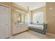Spacious bathroom with double vanity, soaking tub with mosaic tile surround and glass block window at 622 147Th E St, Bradenton, FL 34212