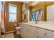 Bathroom featuring a white vanity, bright lighting, and a patterned shower curtain at 622 147Th E St, Bradenton, FL 34212
