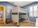 Cozy bedroom featuring white bunk bed with desk, blue walls, and a comfortable carpet at 622 147Th E St, Bradenton, FL 34212