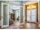 An inviting foyer with hardwood floors and view to a home office space providing a welcoming atmosphere at 622 147Th E St, Bradenton, FL 34212