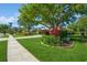 Landscaped front yard with mature trees and a lush garden, creating a welcoming entrance to this charming home at 622 147Th E St, Bradenton, FL 34212
