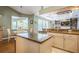 Beautiful kitchen with granite counters, island, and bar seating with modern appliances overlooking the living area at 622 147Th E St, Bradenton, FL 34212