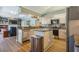 Bright kitchen with modern appliances, granite counters, an island, and open view to the living area at 622 147Th E St, Bradenton, FL 34212
