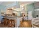 Kitchen with granite counters, stainless appliances, bar seating, and breakfast nook with wood-style flooring at 622 147Th E St, Bradenton, FL 34212