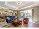 Living room featuring a view into the backyard pool, and kitchen with access through sliding glass doors at 622 147Th E St, Bradenton, FL 34212