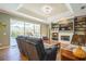 Open living room with fireplace, built-in shelving, wood floors, and view of screened-in pool area at 622 147Th E St, Bradenton, FL 34212