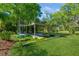 A backyard featuring a custom-built play area with artificial turf and various play structures at 622 147Th E St, Bradenton, FL 34212