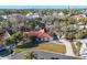 Aerial view showcases a red tile roof home nestled among mature trees and lush landscaping at 670 Venice Ln, Sarasota, FL 34242