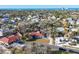 Expansive aerial view showcasing a neighborhood near the ocean with mature trees and well-maintained homes at 670 Venice Ln, Sarasota, FL 34242