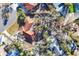 Overhead view showcases a red tile roof home nestled among mature trees and lush landscaping at 670 Venice Ln, Sarasota, FL 34242