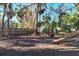 Spacious backyard area featuring lush greenery and an opportunity for landscaping at 670 Venice Ln, Sarasota, FL 34242