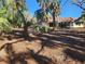 Rear view of home, showing backyard bordered with foliage and landscaping opportunities at 670 Venice Ln, Sarasota, FL 34242