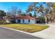 Charming single-story home featuring a red tile roof, stucco walls, and a well-manicured lawn in front at 670 Venice Ln, Sarasota, FL 34242