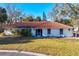 Attractive single-story home featuring a red tile roof and a green lawn at 670 Venice Ln, Sarasota, FL 34242