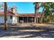 A cozy home featuring a red tile roof and a screened-in porch amidst lush, tropical landscaping at 670 Venice Ln, Sarasota, FL 34242