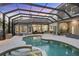Expansive backyard with a screened-in pool, spa, and patio, creating a perfect entertainment space at 7257 Greystone St, Lakewood Ranch, FL 34202