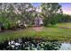 Scenic backyard view with a pond and lush greenery, providing a tranquil setting at 7257 Greystone St, Lakewood Ranch, FL 34202