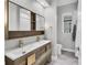 Well-lit bathroom with a double vanity, sleek fixtures, and modern decor at 7257 Greystone St, Lakewood Ranch, FL 34202