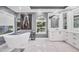 Elegant bathroom featuring a freestanding tub, white marble floors, and a vanity with ample storage at 7257 Greystone St, Lakewood Ranch, FL 34202