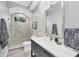 Stylish bathroom with a shower, dark vanity, white marble countertop, and modern finishes at 7257 Greystone St, Lakewood Ranch, FL 34202