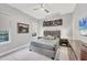 Comfortable bedroom with neutral tones, a gray bed, and ample natural light at 7257 Greystone St, Lakewood Ranch, FL 34202