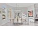 Formal dining room with modern lighting, stylish decor, and an open view into the living room and kitchen at 7257 Greystone St, Lakewood Ranch, FL 34202
