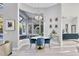 Cozy dining area with a round table, blue chairs, modern lighting, and a view to the lanai at 7257 Greystone St, Lakewood Ranch, FL 34202