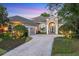 Stately home featuring manicured landscaping, a paver driveway and a grand double-door entrance with white columns at 7257 Greystone St, Lakewood Ranch, FL 34202