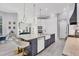 Contemporary kitchen featuring a spacious island with seating and stylish white and navy cabinetry at 7257 Greystone St, Lakewood Ranch, FL 34202