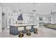 Modern kitchen featuring a large island with seating, pendant lighting, and high-end appliances and finishes at 7257 Greystone St, Lakewood Ranch, FL 34202