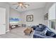 Comfortable living room with a blue sectional, neutral decor, and a flat-screen TV at 7257 Greystone St, Lakewood Ranch, FL 34202
