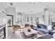 Bright living room featuring a fireplace, comfortable seating and an open layout leading to the dining area at 7257 Greystone St, Lakewood Ranch, FL 34202