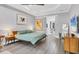 Serene bedroom with gray walls, a modern bed, tray ceiling, art, and wood floors at 7257 Greystone St, Lakewood Ranch, FL 34202