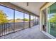 Spacious screened patio with a ceiling fan, tiled floor, and views of the backyard at 7257 Greystone St, Lakewood Ranch, FL 34202