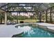 Backyard oasis showcasing a screened-in pool, spa, and lush landscaping, perfect for relaxation at 7257 Greystone St, Lakewood Ranch, FL 34202
