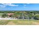Sprawling aerial view of the community clubhouse, golf course, and meticulously maintained parking area at 7261 Villa D Este Dr, Sarasota, FL 34238