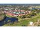 Community aerial view of lush, well-kept properties overlooking a lake and golf course at 7261 Villa D Este Dr, Sarasota, FL 34238