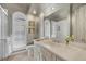 Updated bathroom featuring a large mirror, white vanity, and glass shower enclosure at 7261 Villa D Este Dr, Sarasota, FL 34238
