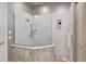 Modern bathroom features a glass shower, tiled accents, and wall-mounted storage at 7261 Villa D Este Dr, Sarasota, FL 34238
