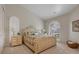 Charming bedroom featuring a floral bedspread, ample lighting, and a decorative nightstand at 7261 Villa D Este Dr, Sarasota, FL 34238