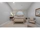 Bedroom features neutral decor, plush carpeting, and ample seating, creating a peaceful retreat at 7261 Villa D Este Dr, Sarasota, FL 34238