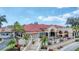 Stunning clubhouse featuring outdoor seating and lush landscaping, perfect for community gatherings and relaxation at 7261 Villa D Este Dr, Sarasota, FL 34238