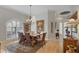 Bright dining room with chandelier features hardwood floors, and a wooden table perfect for entertaining at 7261 Villa D Este Dr, Sarasota, FL 34238