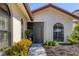 Inviting front entrance with well-maintained landscaping, arched windows, and a secure gate at 7261 Villa D Este Dr, Sarasota, FL 34238
