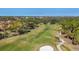 Scenic aerial view of the well-manicured golf course surrounded by lush trees and residential housing at 7261 Villa D Este Dr, Sarasota, FL 34238