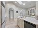 Well-appointed kitchen features white cabinets, a large island with seating, and stainless appliances at 7261 Villa D Este Dr, Sarasota, FL 34238