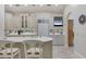Bright, white kitchen featuring custom cabinets, a kitchen island, and stainless steel appliances at 7261 Villa D Este Dr, Sarasota, FL 34238