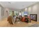 Expansive living room with light hardwood floors, neutral paint, and plenty of natural light from large windows at 7261 Villa D Este Dr, Sarasota, FL 34238