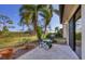 Charming patio with outdoor seating overlooking a beautifully landscaped yard at 7261 Villa D Este Dr, Sarasota, FL 34238