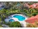 Stunning aerial view of pool and spa surrounded by lounge chairs, landscaping, and community residences at 7261 Villa D Este Dr, Sarasota, FL 34238